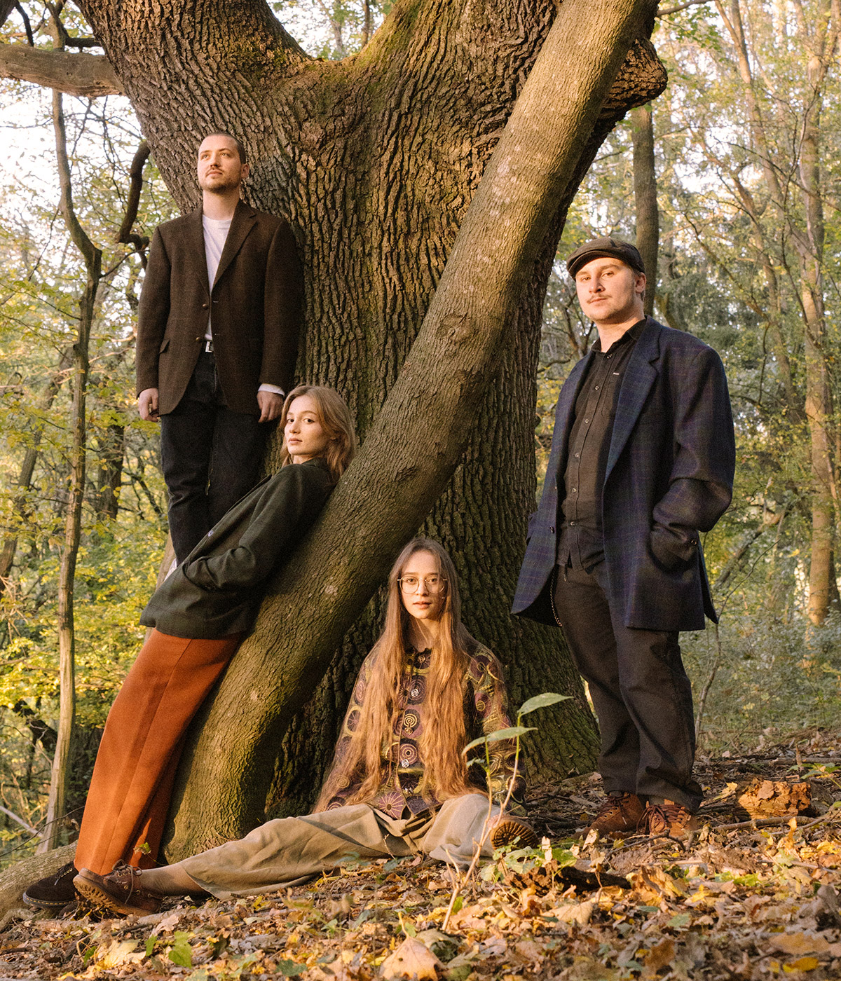 Musiker der band stehen um einen Baum